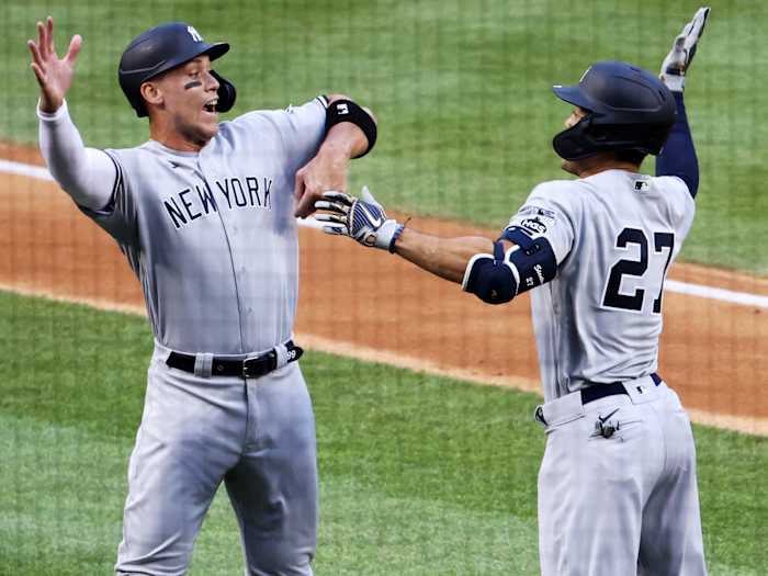 Jul 23, 2020; Washington, DC, USA; New York Yankees designated hitter Giancarlo Stanton (27) celebrates with right fielder Aaron Judge (99) after hitting a two-run home run against the New York Yankees in the first inning during MLB Opening Day at Nationals Park.